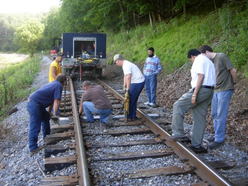 crew of men inspecting railroad ties
